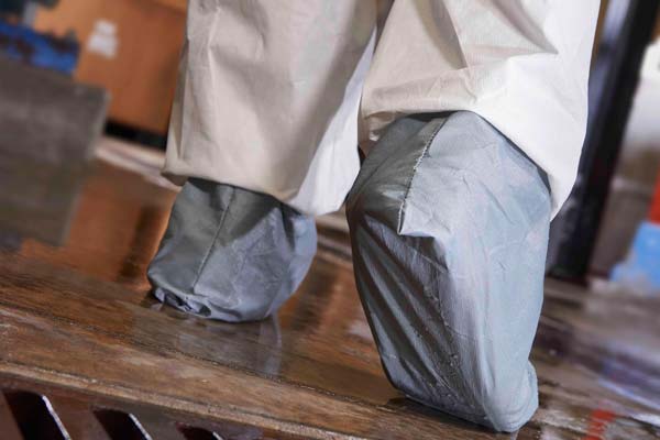 Coveralls with skid-resistant boots